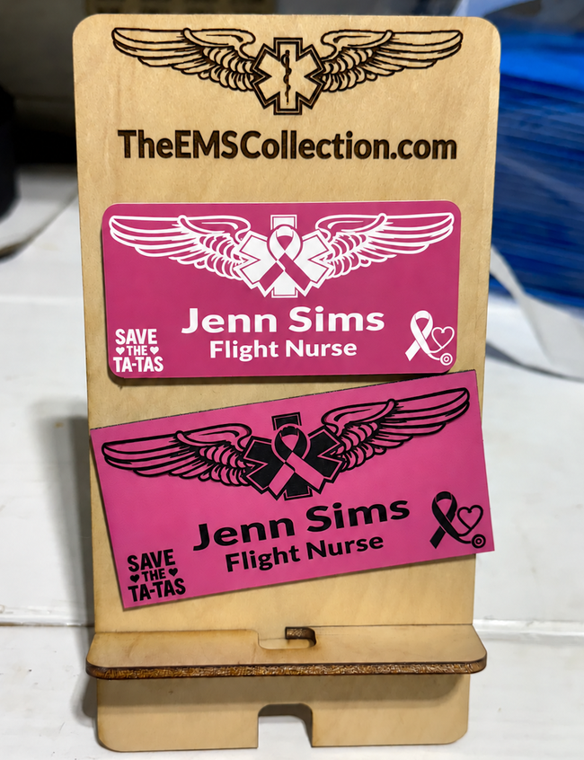 Name badge beside the pink leatherette flight badge